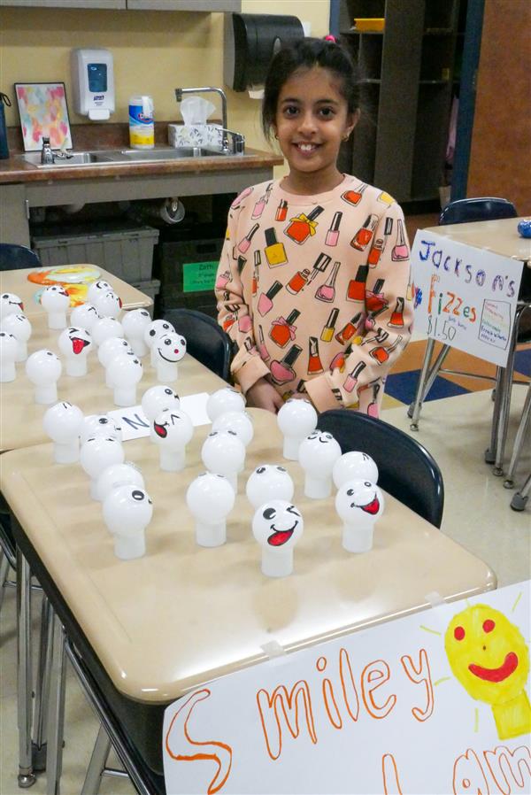 girl selling smiley balls